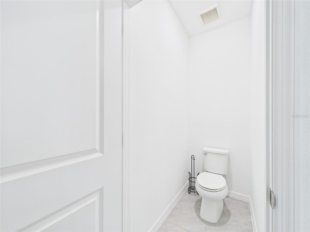 2033 Emerald Springs Drive Apopka, FL 32712 - Photo 36 of 49 a white toilet sitting next to a white cabinet