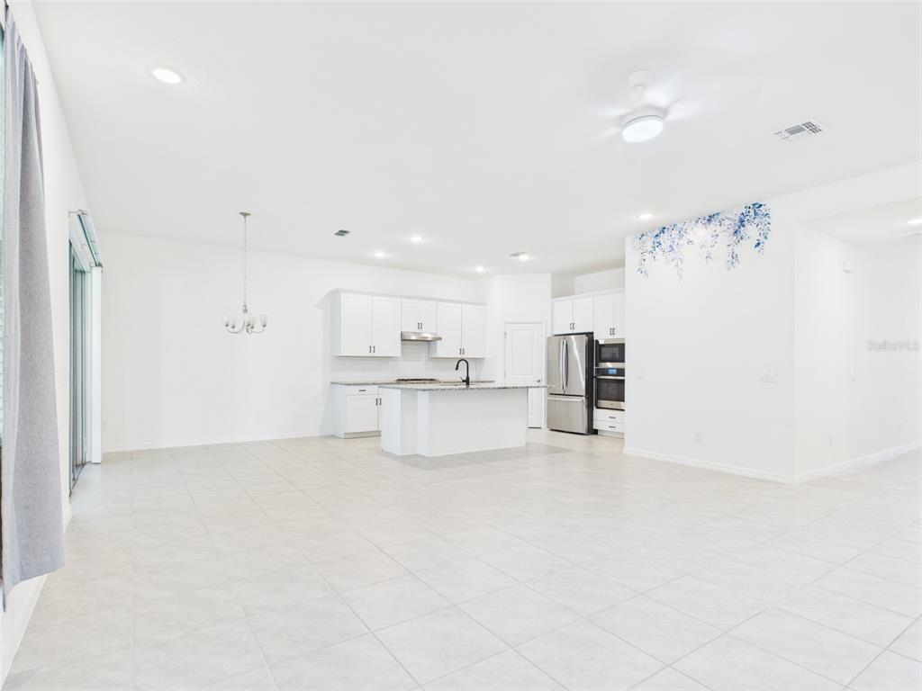 2033 Emerald Springs Drive Apopka, FL 32712 - Photo 7 of 49 a view of kitchen with refrigerator and window