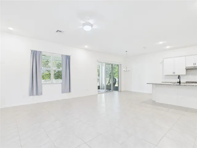 a kitchen with refrigerator and microwave