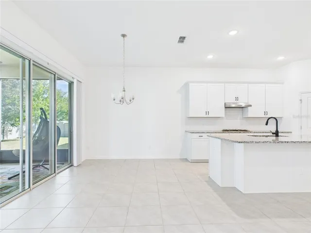 a spacious bathroom with a granite countertop sink and a mirror