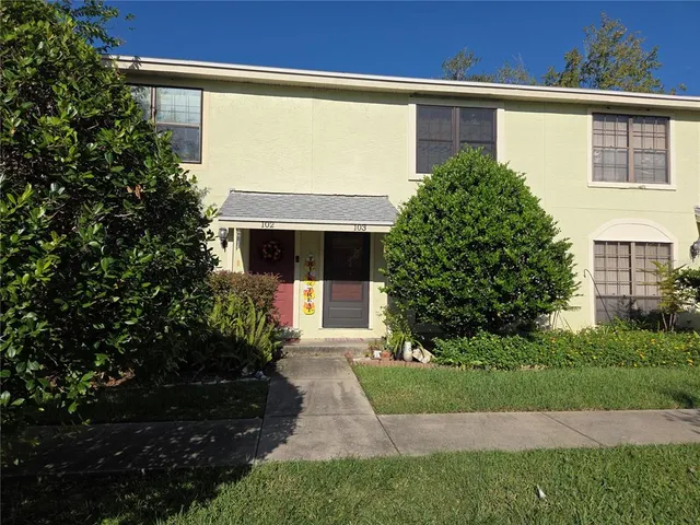a front view of a house with a yard and a garage