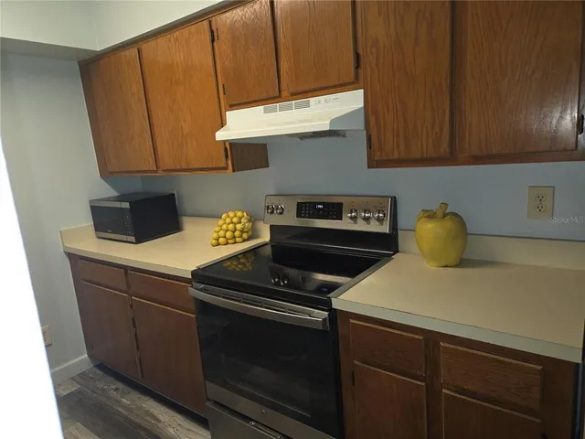 a kitchen with a stove and a microwave