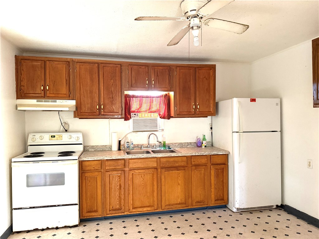 147 County Road 153 Alice, TX 78332 - Photo 13 of 23 a kitchen with a sink a stove and refrigerator