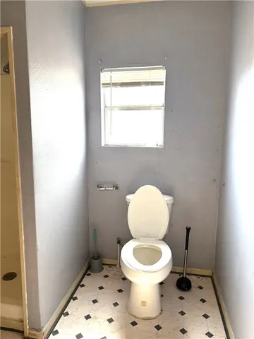 a bathroom with a sink a toilet and mirror