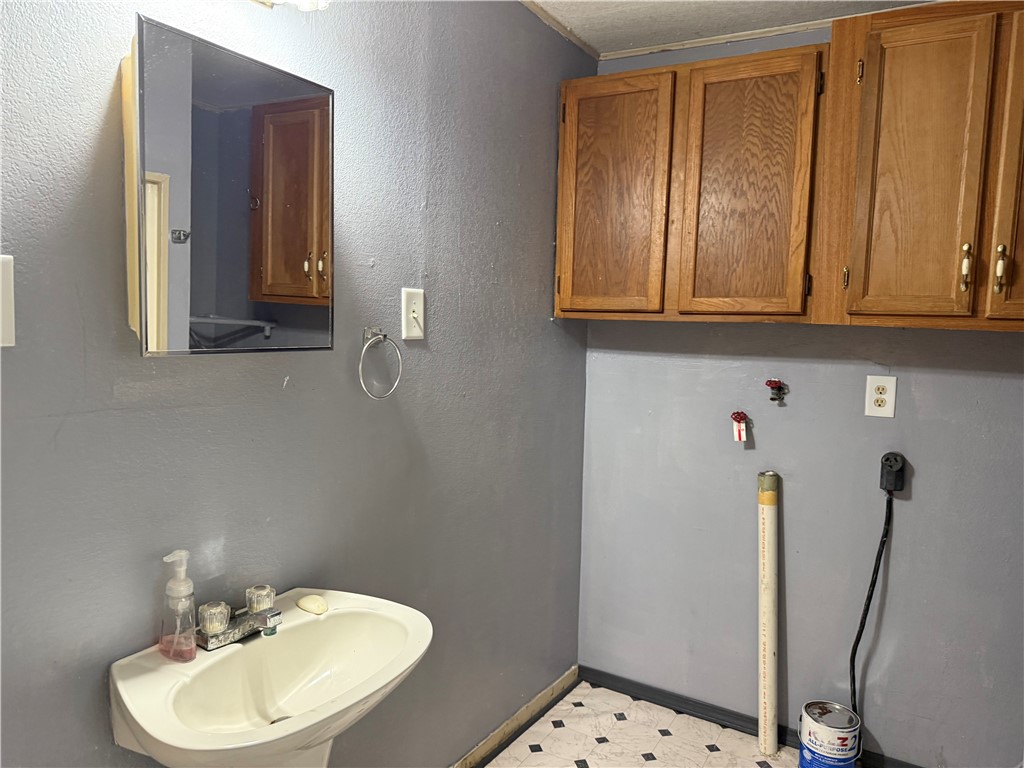 147 County Road 153 Alice, TX 78332 - Photo 19 of 23 a bathroom with a sink a toilet and mirror