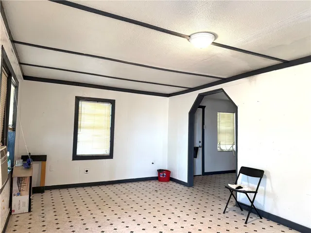 a view of a hallway with wooden floor and entryway