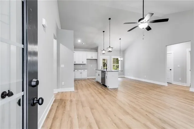 wooden floor in an empty room with a kitchen