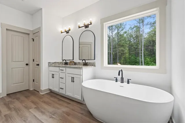 a white bath tub sitting next to a bathroom sink