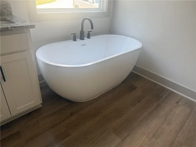 a white bath tub sitting in a bathroom
