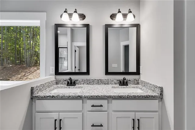 a bathroom with a granite countertop sink and a mirror