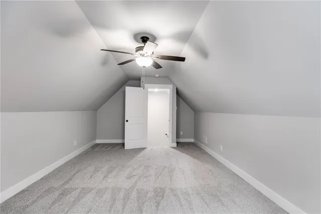 a view of a chandelier fan and a ceiling fan in a room