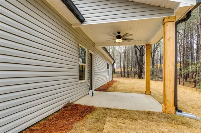a view of a porch with a table and chairs
