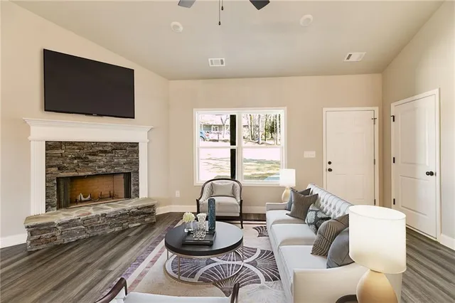 a living room with furniture fireplace and flat screen tv