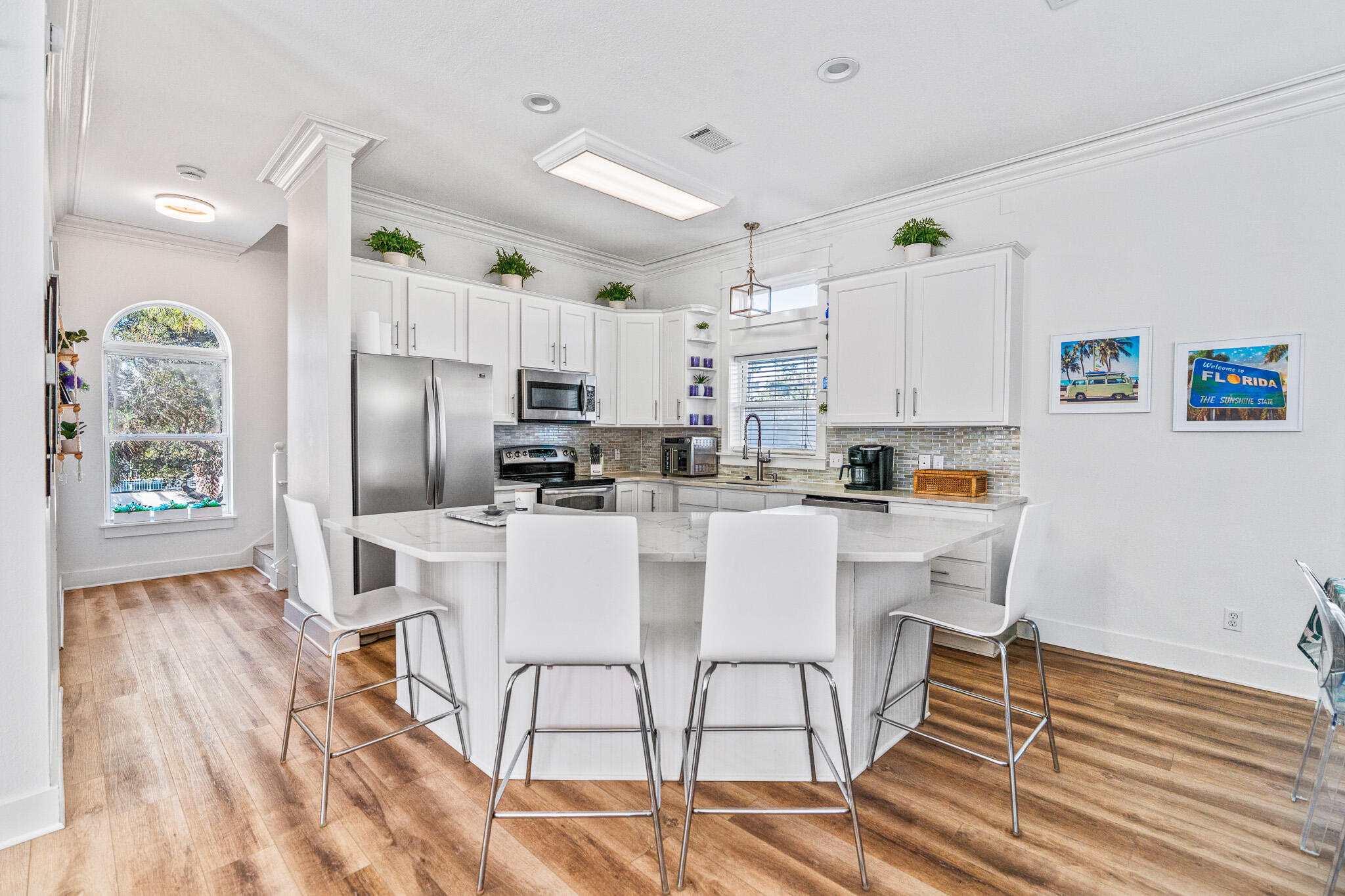 15 Beachwalk Lane Santa Rosa Beach, FL 32459 - Photo 13 of 26 a kitchen with stainless steel appliances a refrigerator a stove a sink dishwasher and white cabinets with wooden floor