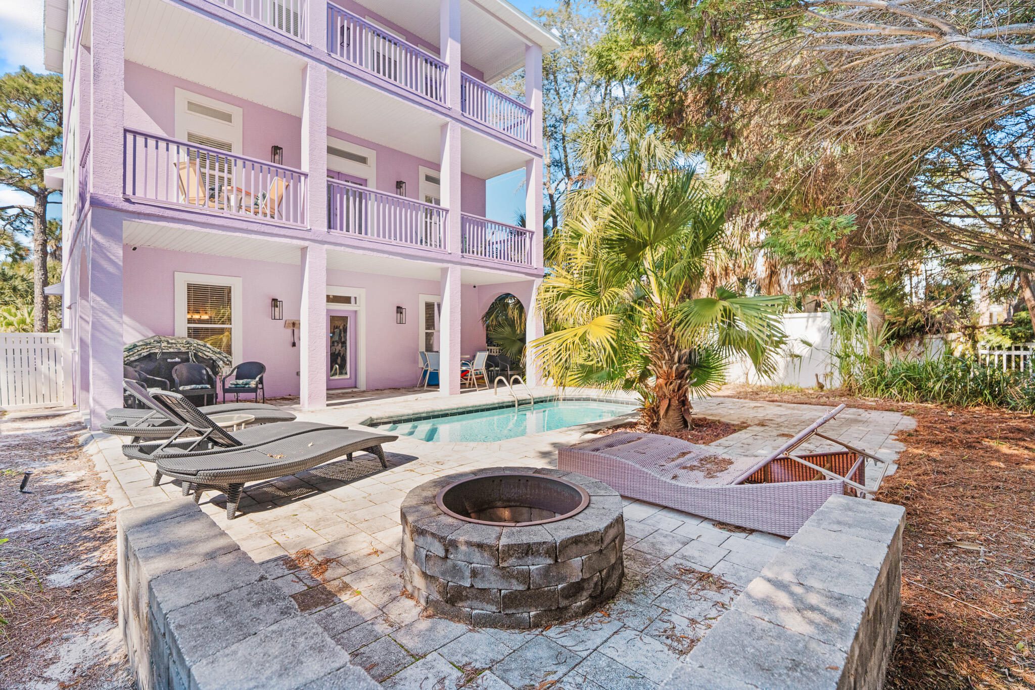 15 Beachwalk Lane Santa Rosa Beach, FL 32459 - Photo 23 of 26 a view of a patio with couches and table and chairs and potted plants