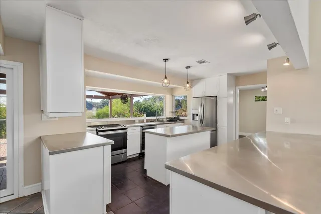 a kitchen with a sink stove and refrigerator