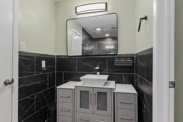 a bathroom with a sink and a mirror