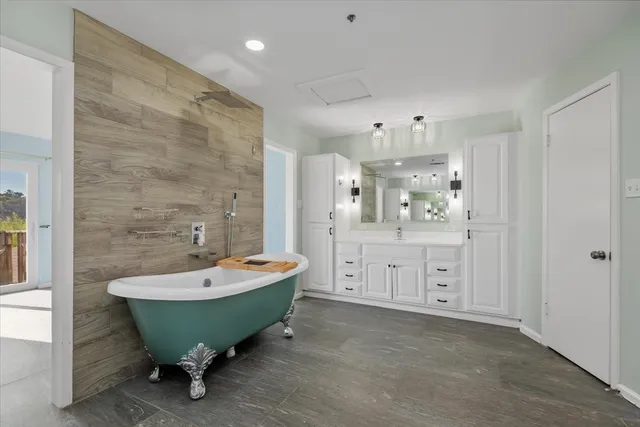 a spacious bathroom with a sink bathtub and a shower