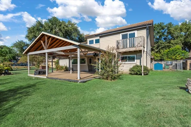 a view of a house with a yard and sitting area
