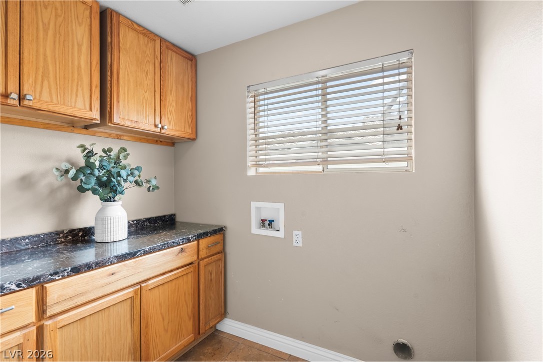 708 Vortex Avenue Henderson, NV 89002 - Photo 22 of 71 Functional laundry room offers ample storage with upper and lower cabinetry, plus convenient utility hookups.