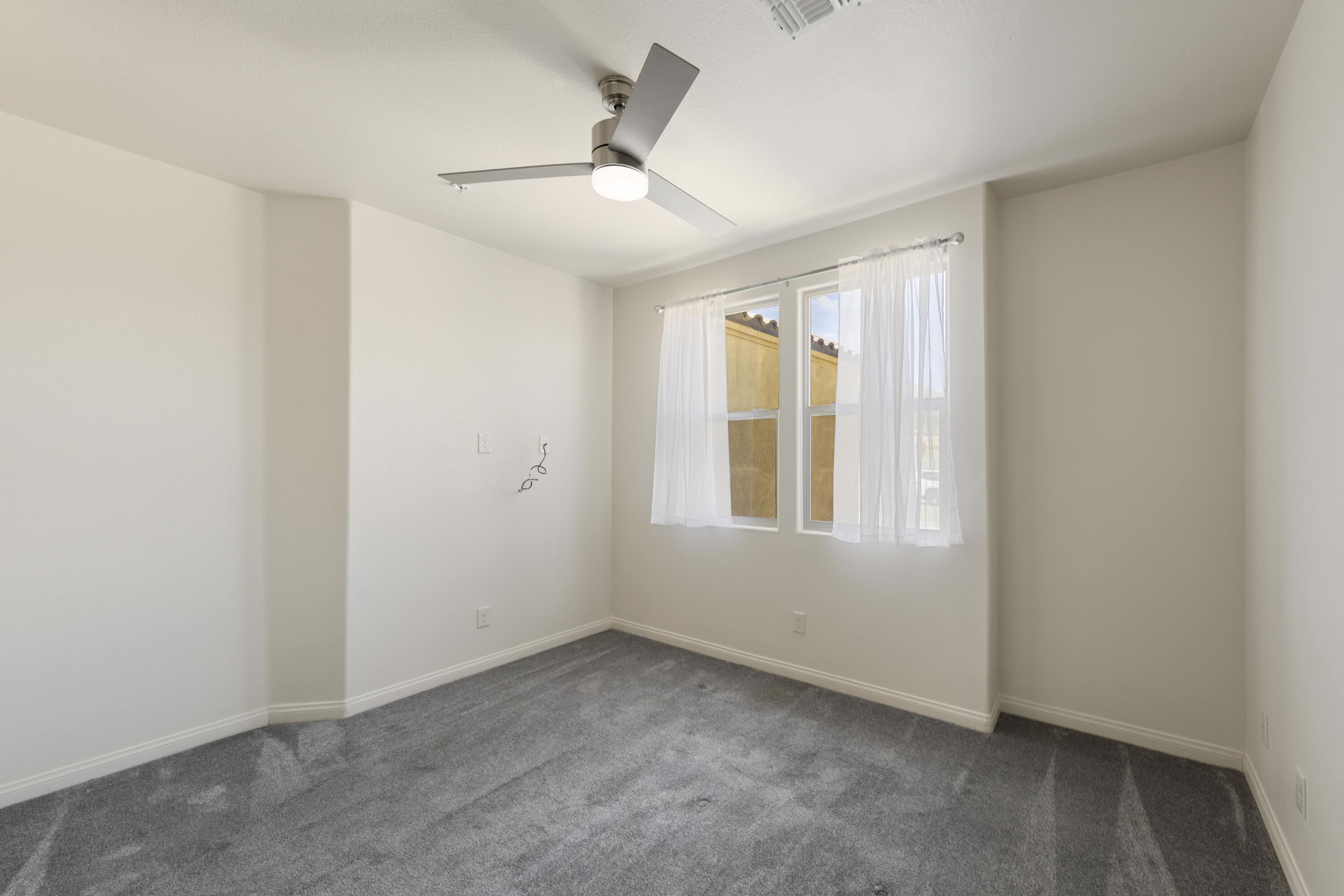 8680 Monument View Drive Yucca Valley, CA 92284 - Photo 13 of 51 an empty room with windows and closet