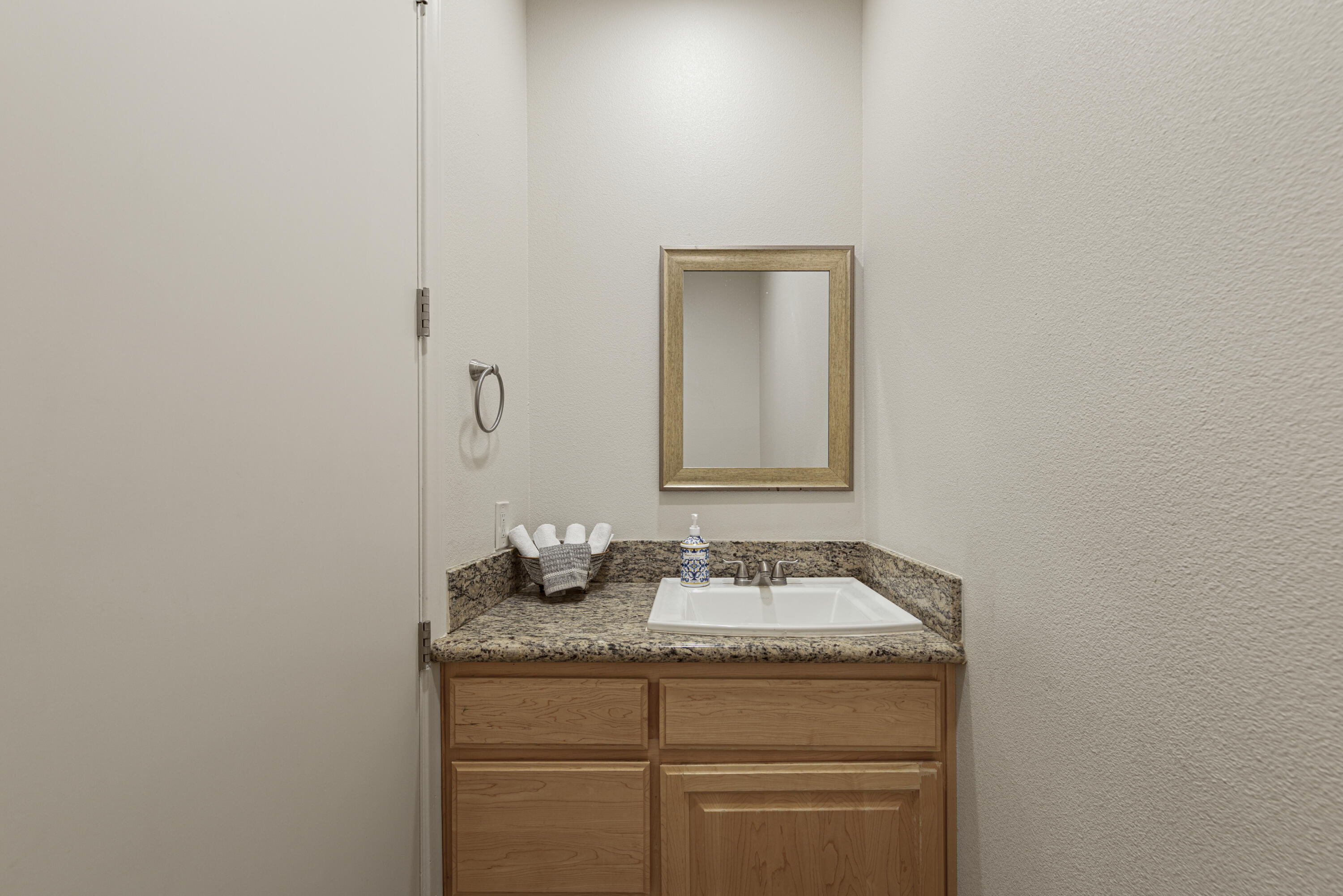 8680 Monument View Drive Yucca Valley, CA 92284 - Photo 14 of 51 a bathroom with a granite countertop sink and a mirror