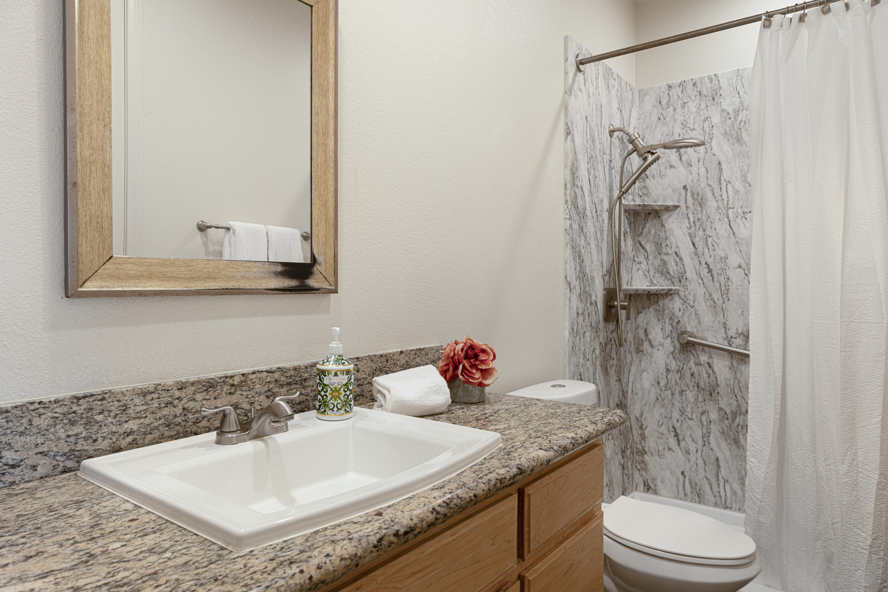 8680 Monument View Drive Yucca Valley, CA 92284 - Photo 18 of 51 a bathroom with a granite countertop sink a toilet and shower