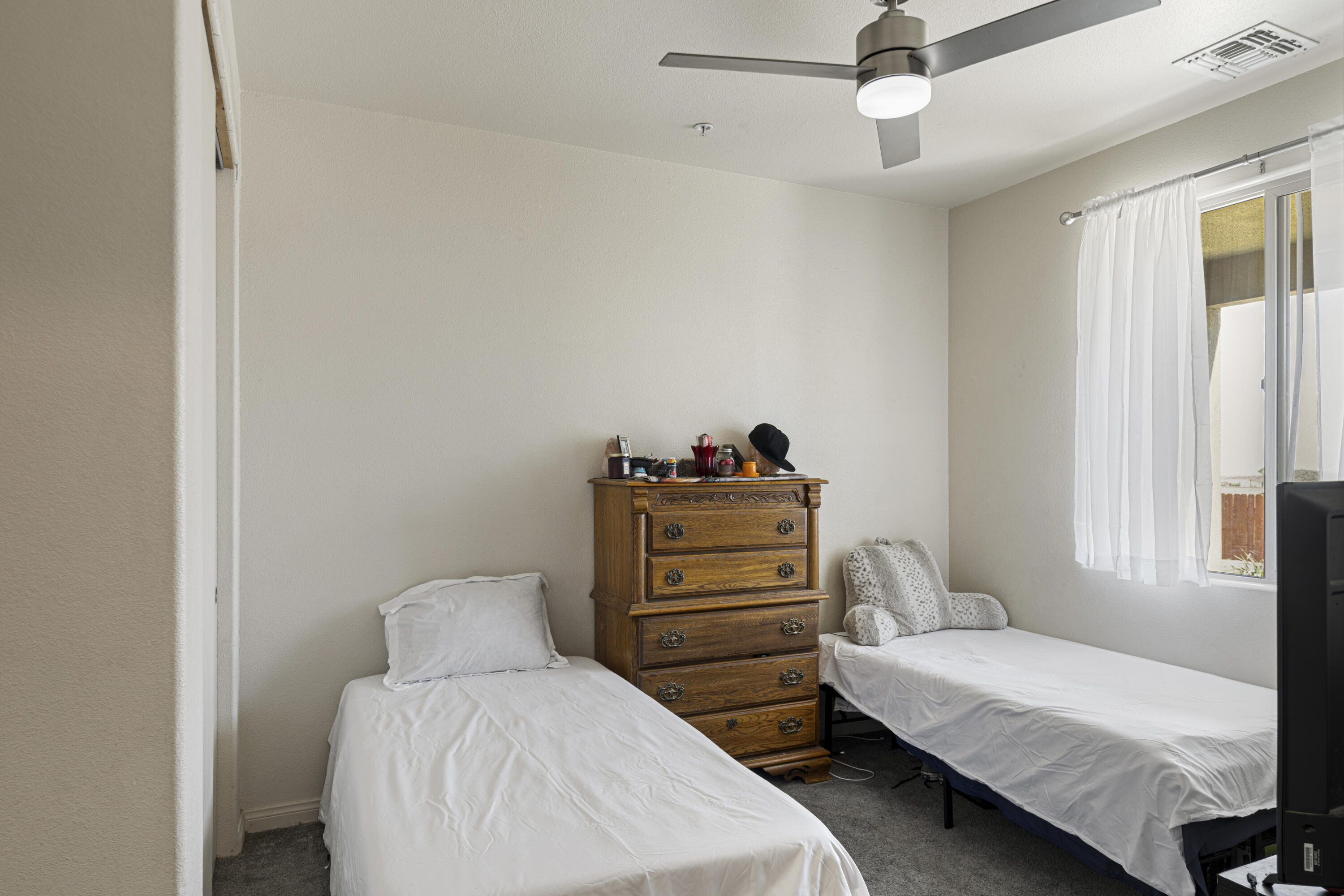 8680 Monument View Drive Yucca Valley, CA 92284 - Photo 19 of 51 a bedroom with a bed and a chandelier