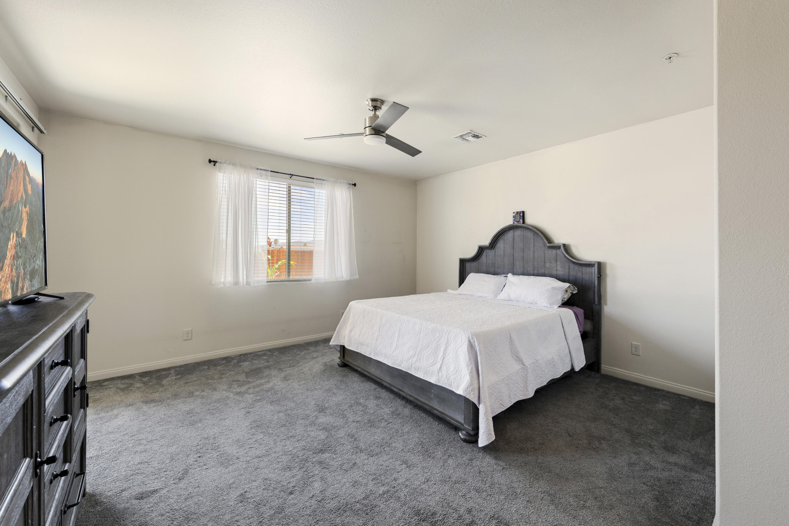 8680 Monument View Drive Yucca Valley, CA 92284 - Photo 21 of 51 a bed sitting in a room next to a window