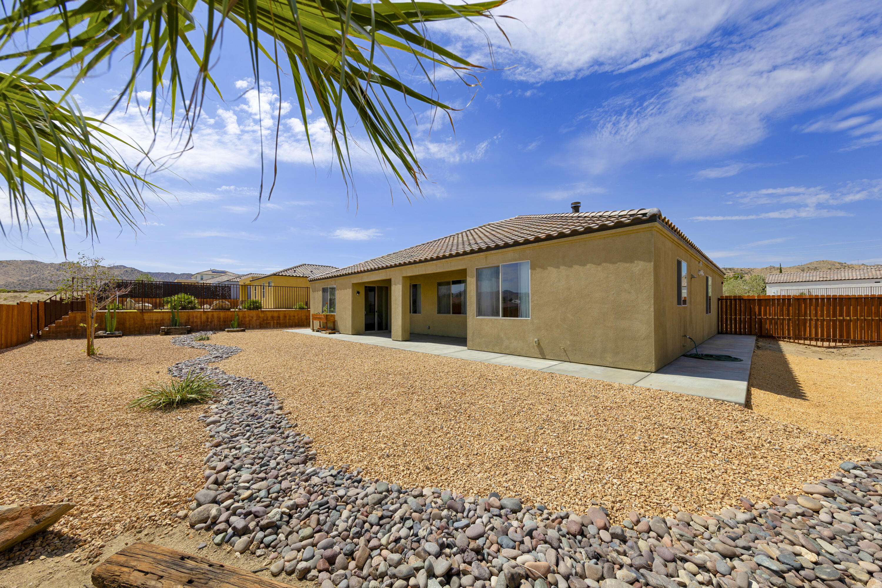 8680 Monument View Drive Yucca Valley, CA 92284 - Photo 27 of 51 a front view of a house with a yard