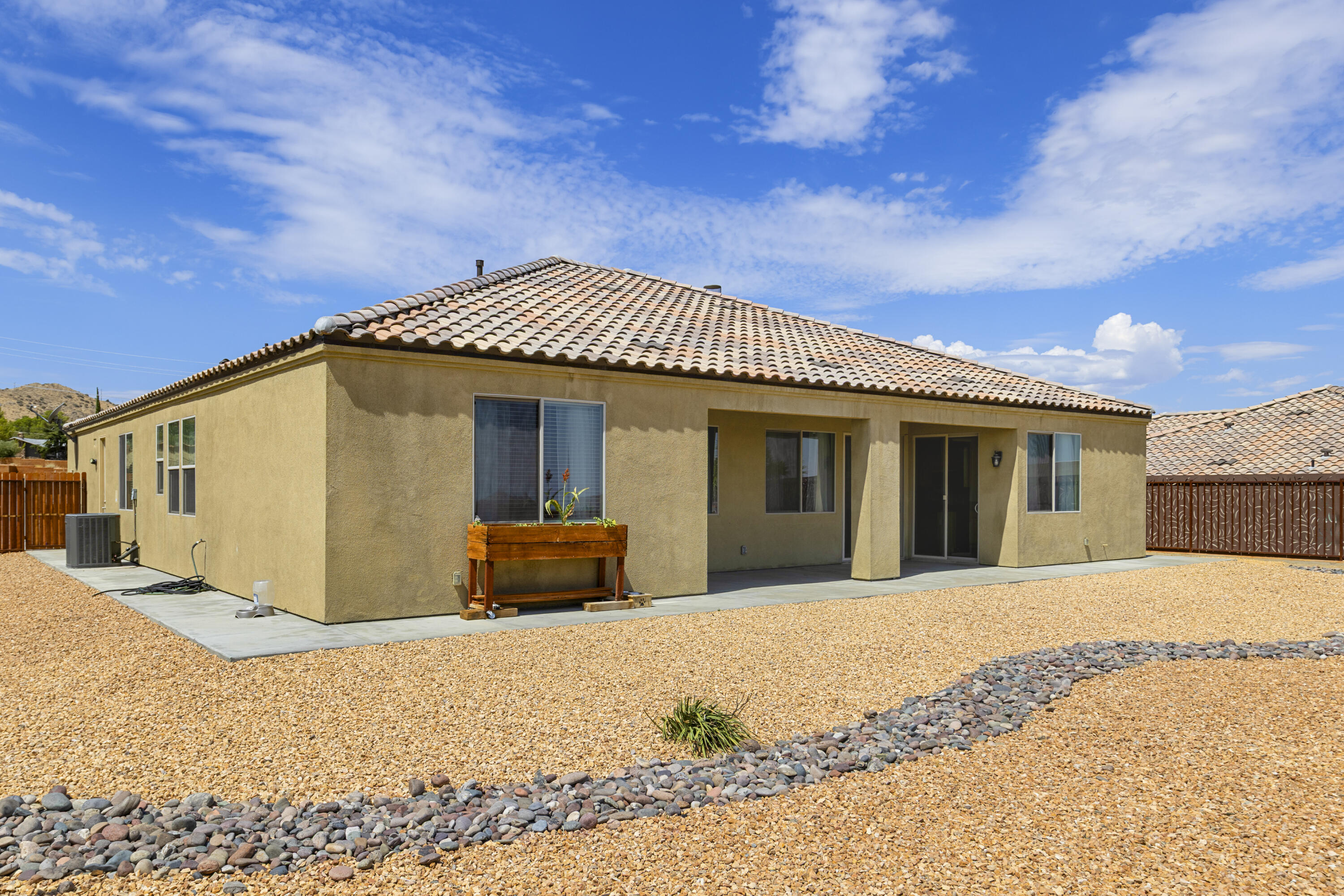 8680 Monument View Drive Yucca Valley, CA 92284 - Photo 28 of 51 a front view of a house with a outdoor space