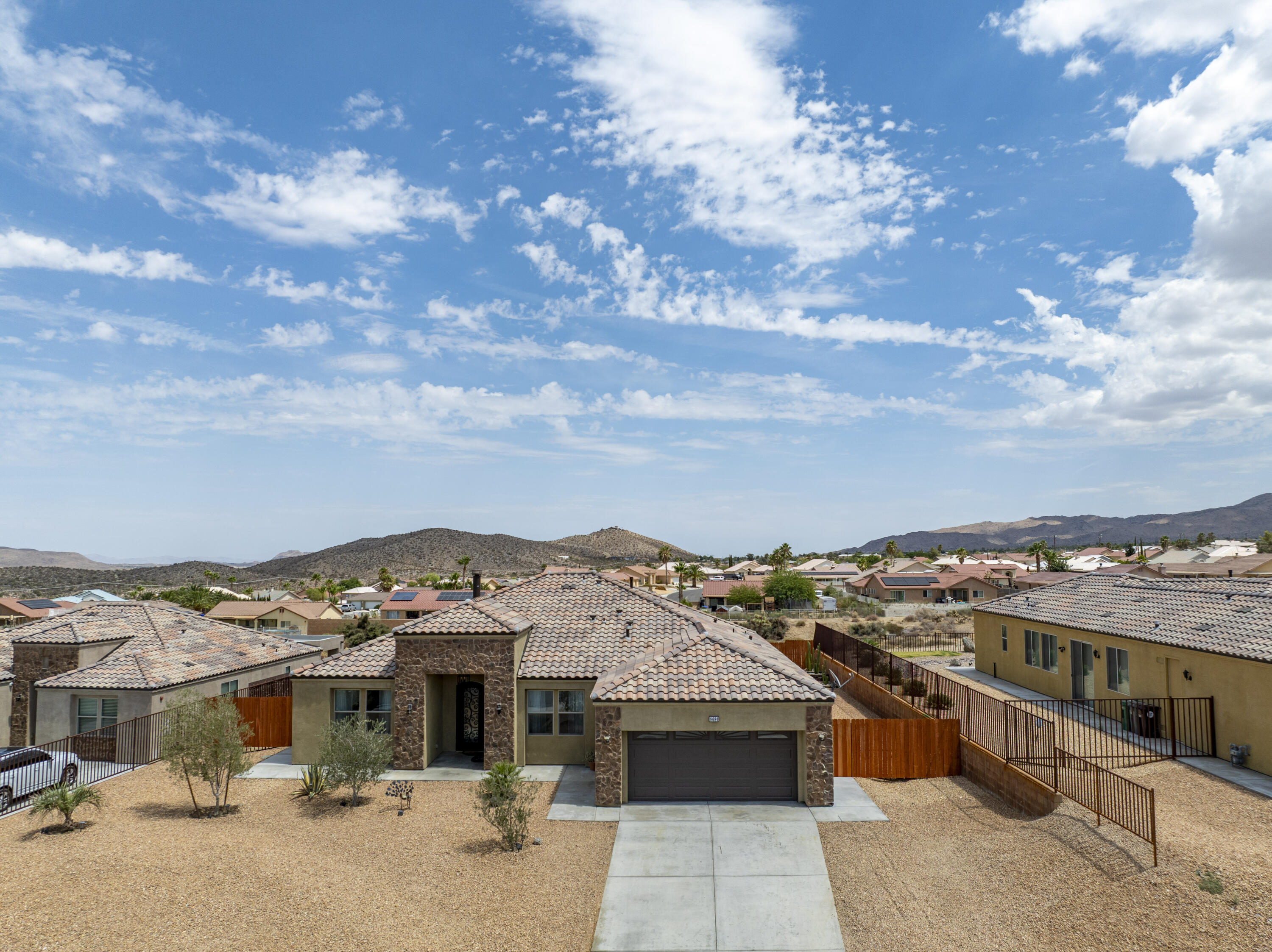 8680 Monument View Drive Yucca Valley, CA 92284 - Photo 35 of 51 a view of a patio with couches under an umbrella