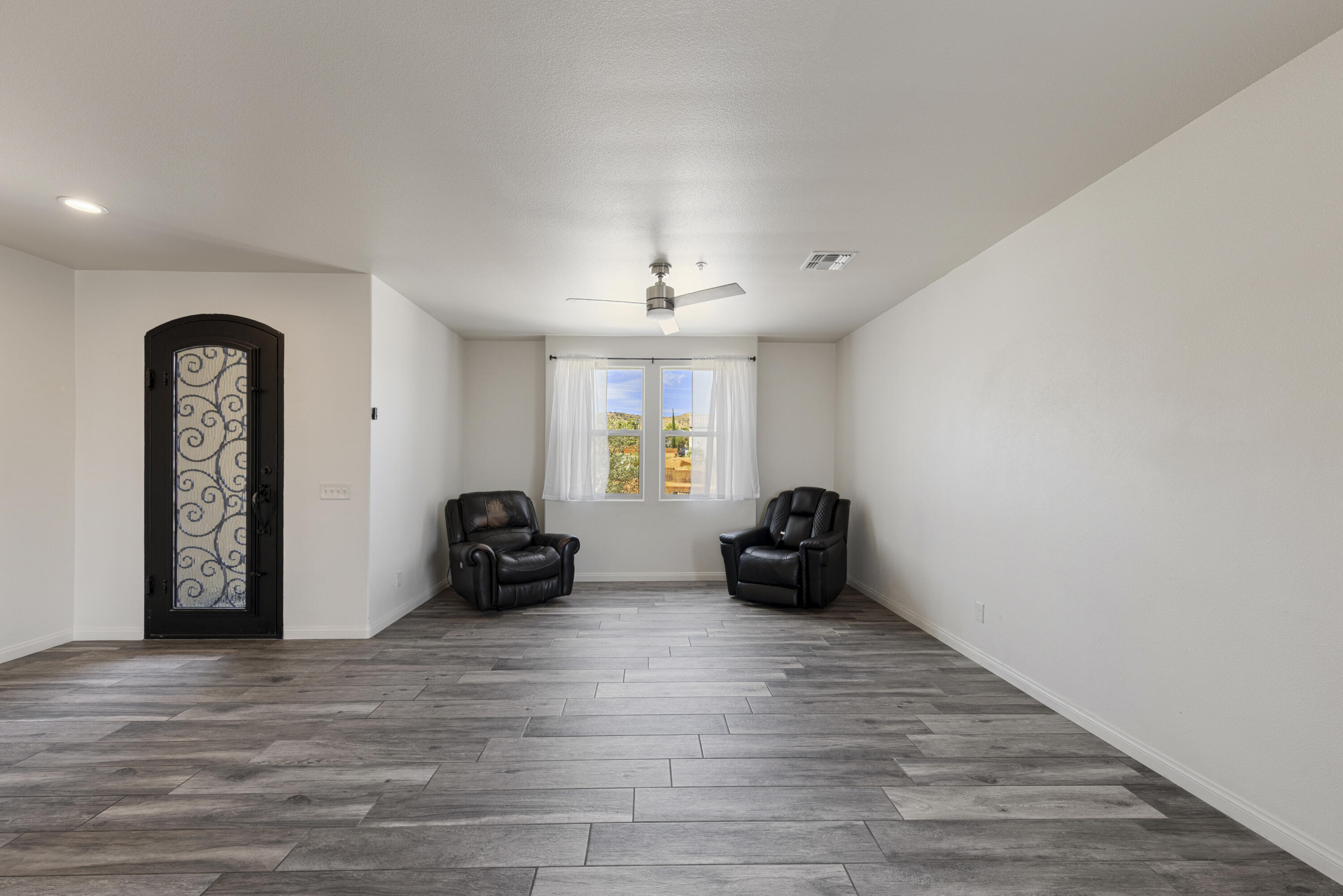8680 Monument View Drive Yucca Valley, CA 92284 - Photo 4 of 51 a living room with furniture and a wooden floor