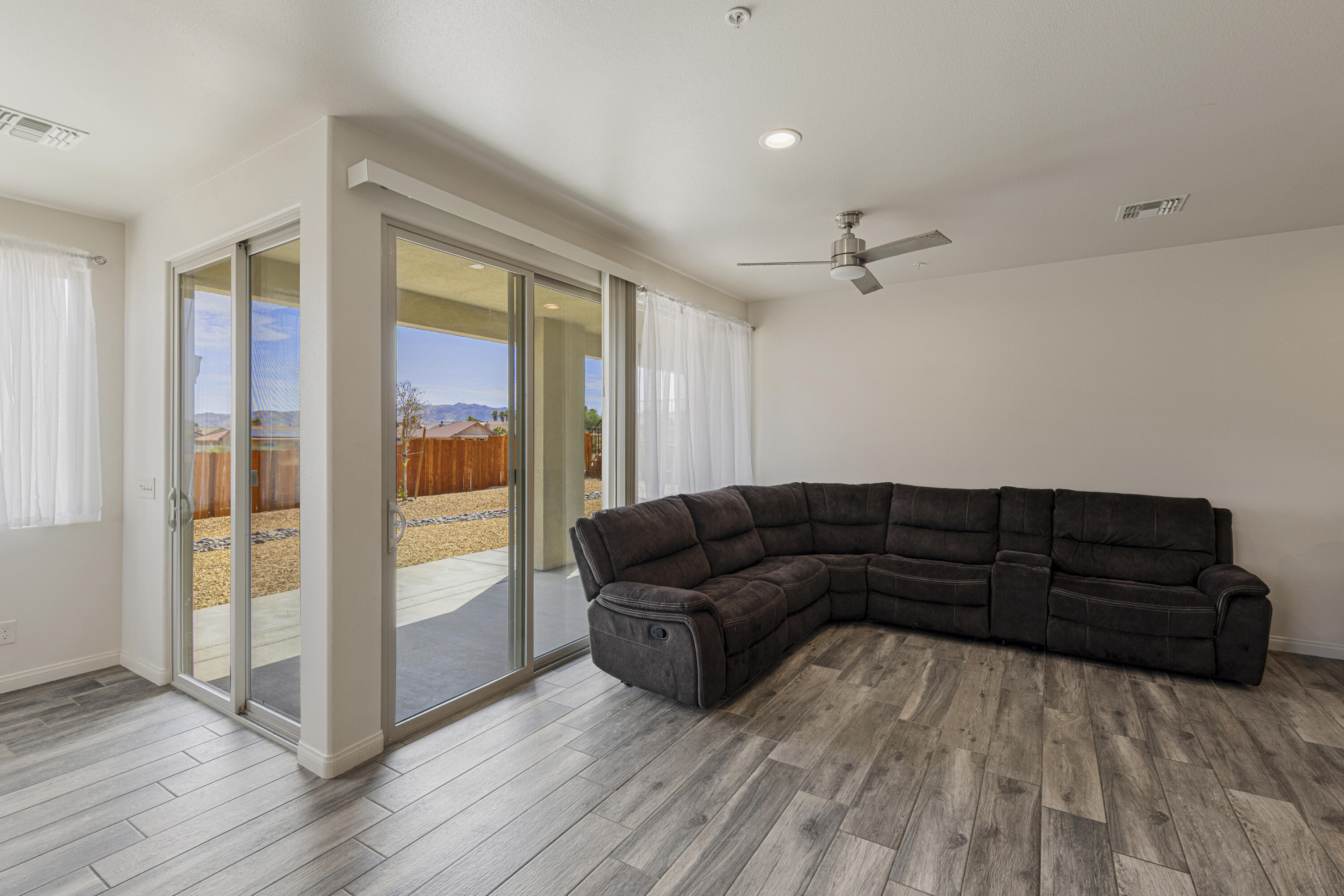 8680 Monument View Drive Yucca Valley, CA 92284 - Photo 10 of 51 a living room with furniture and wooden floor