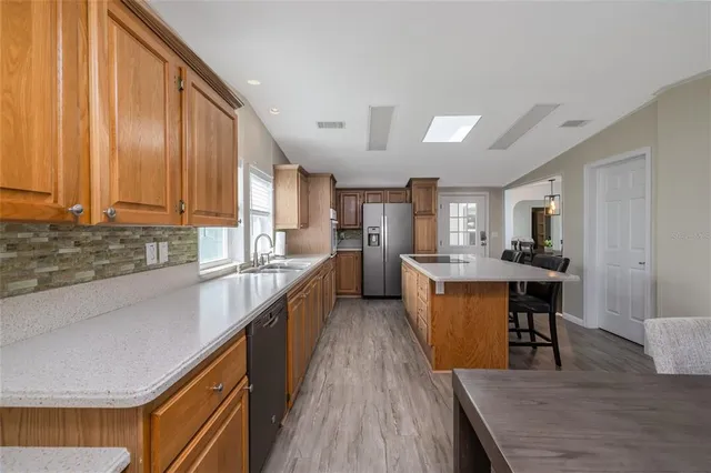 a kitchen with lots of counter top space and center island