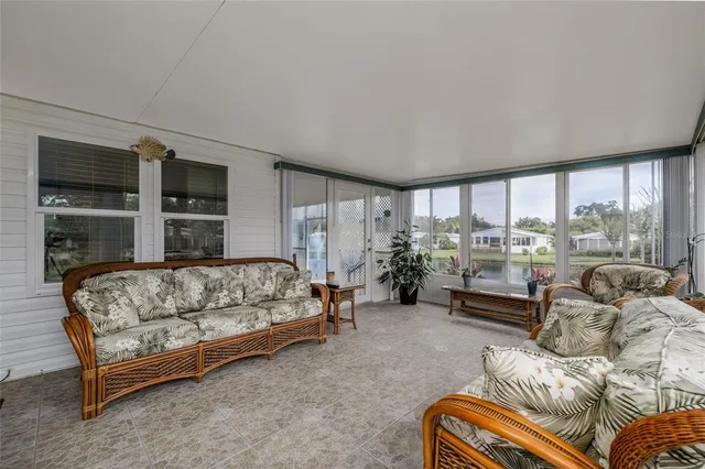 a bedroom with furniture and a large window