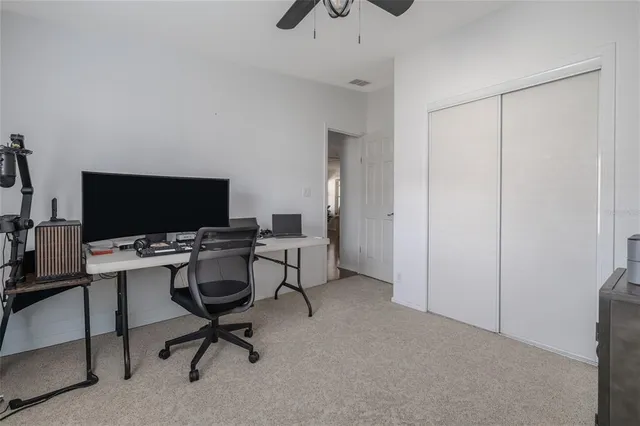 a view of a livingroom with workspace and a window
