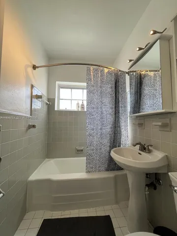 a bathroom with a sink mirror toilet and bathtub