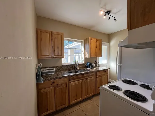 a kitchen with sink a stove and refrigerator