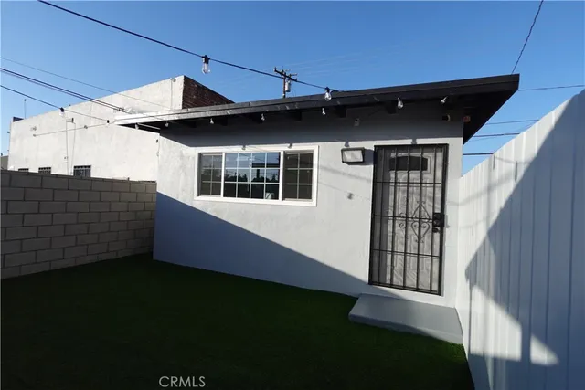 a backyard of a house with wooden fence