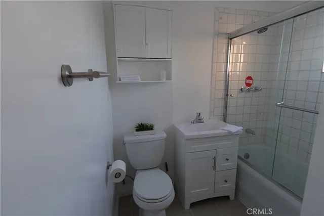 a bathroom with a toilet a sink and shower