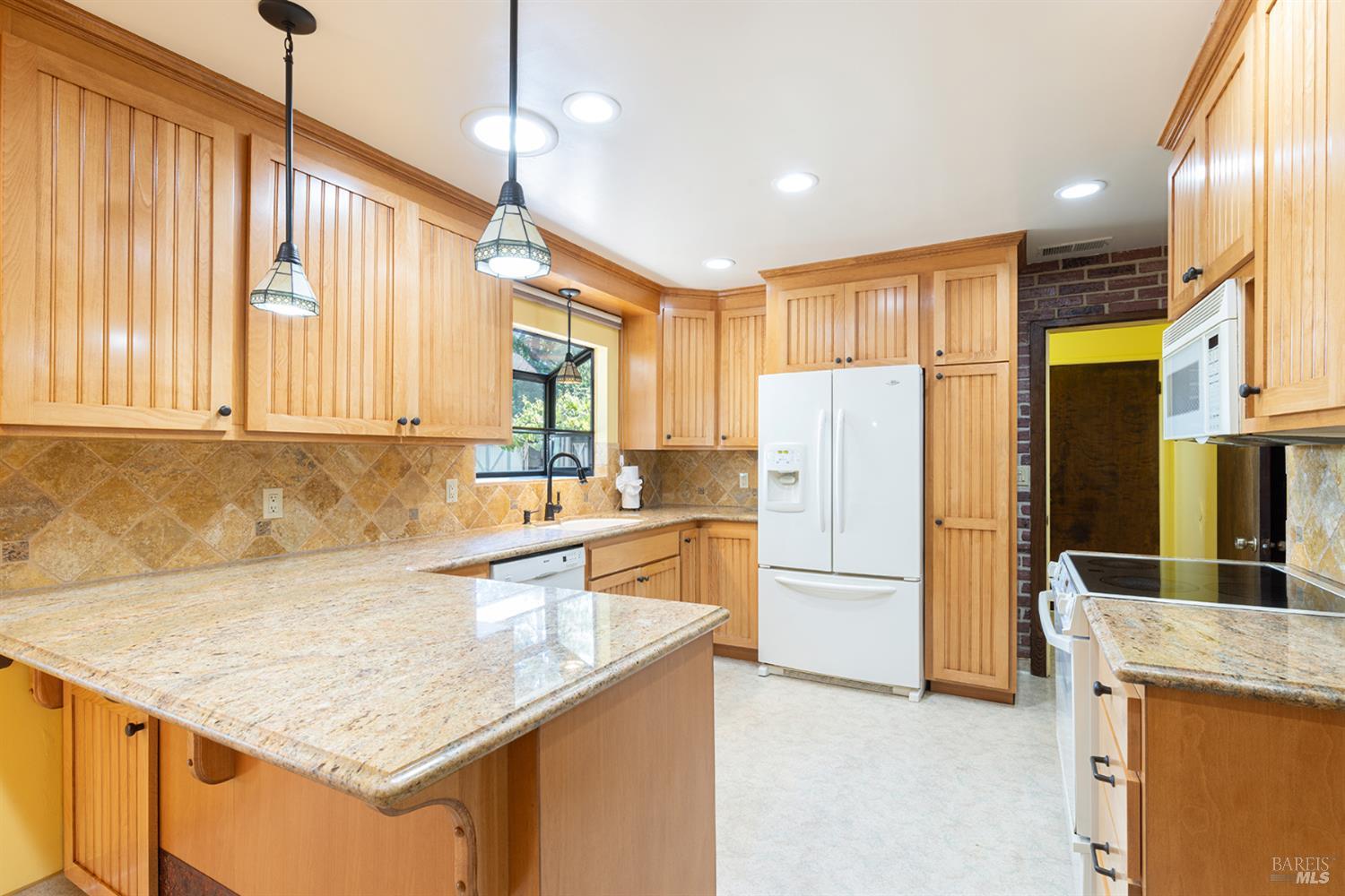 2236 West Hearn Avenue Santa Rosa, CA 95407 - Photo 17 of 56 a kitchen with granite countertop a refrigerator a sink and dishwasher