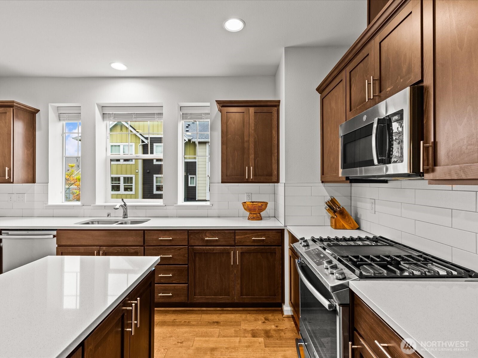 3400 Southwest Graham Street, Unit 703 Seattle, WA 98126 - Photo 13 of 28 a kitchen with stainless steel appliances granite countertop a stove and a sink