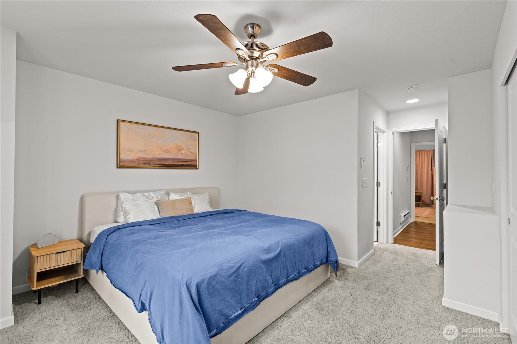 3400 Southwest Graham Street, Unit 703 Seattle, WA 98126 - Photo 15 of 28 a bedroom with a bed and a chandelier