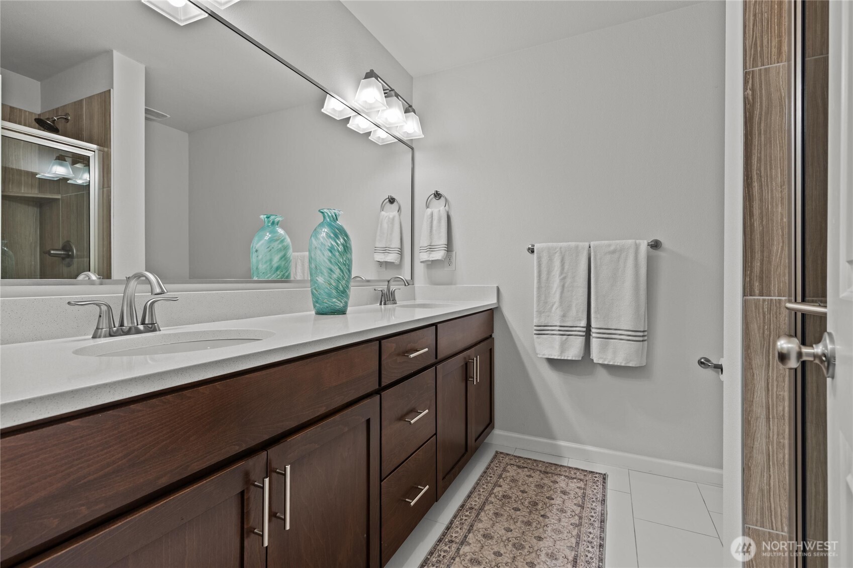 3400 Southwest Graham Street, Unit 703 Seattle, WA 98126 - Photo 16 of 28 a bathroom with a double vanity sink a vanity and a mirror