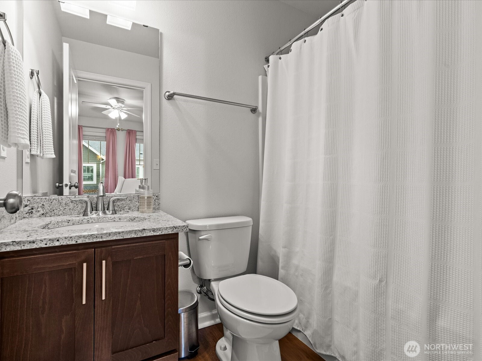 3400 Southwest Graham Street, Unit 703 Seattle, WA 98126 - Photo 21 of 28 a bathroom with a granite countertop toilet sink and mirror