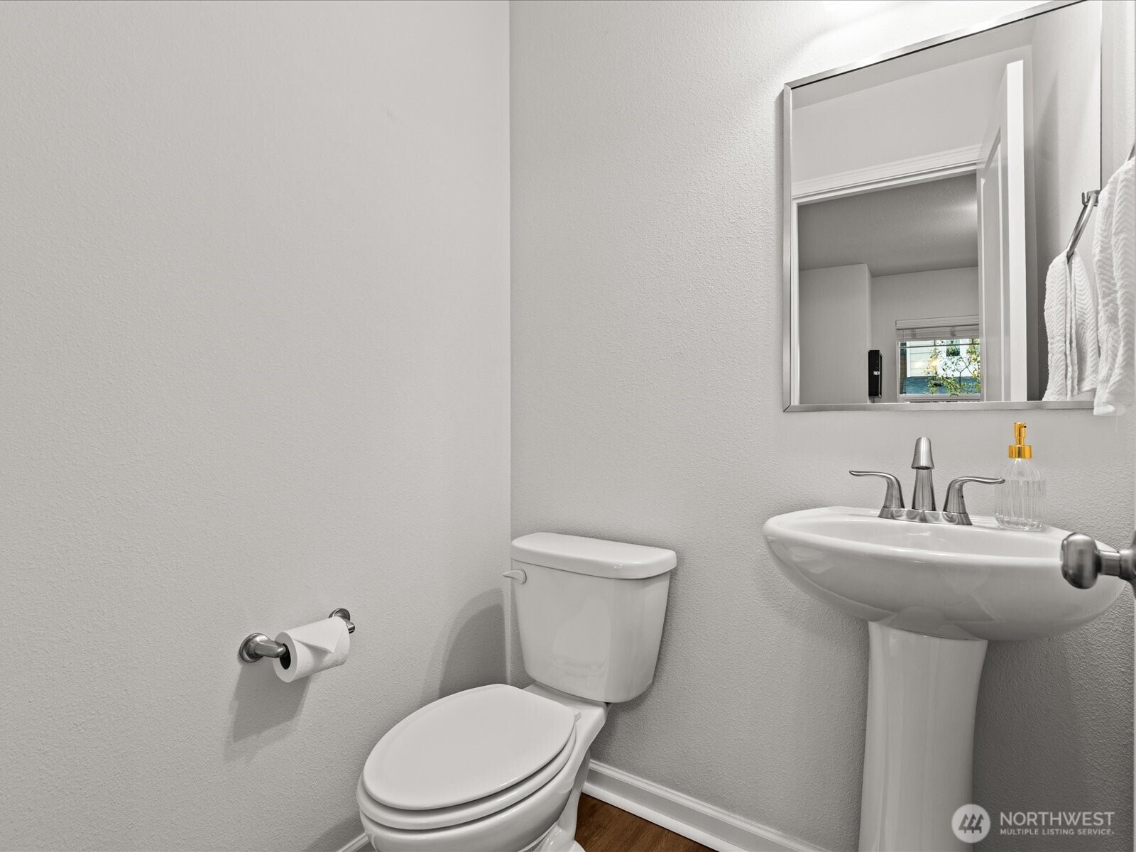 3400 Southwest Graham Street, Unit 703 Seattle, WA 98126 - Photo 23 of 28 a bathroom with a toilet sink and mirror