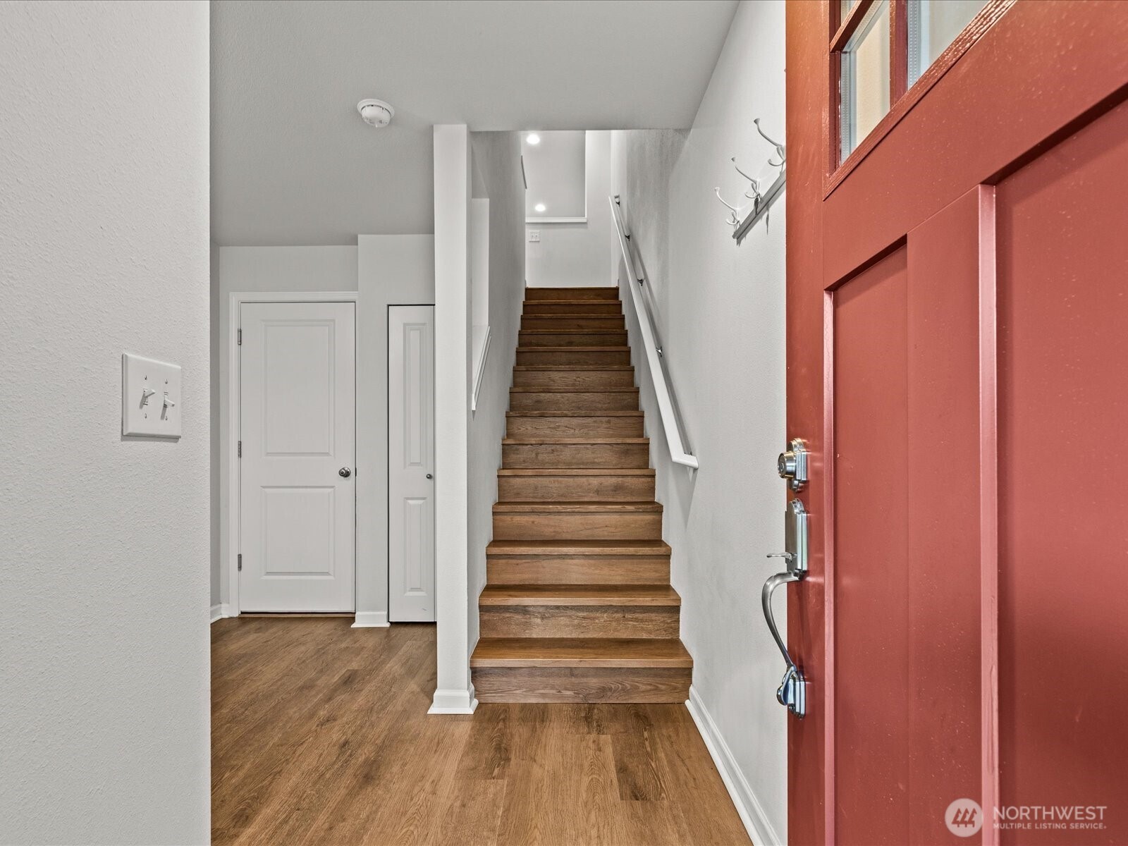3400 Southwest Graham Street, Unit 703 Seattle, WA 98126 - Photo 5 of 28 a view of a hallway with wooden floor and staircase