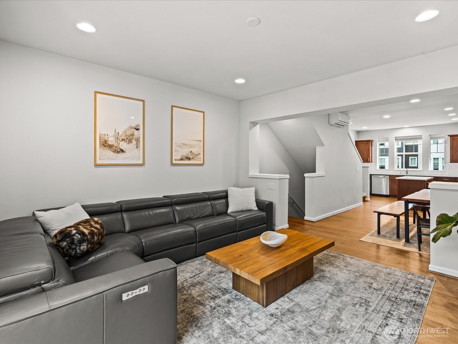 3400 Southwest Graham Street, Unit 703 Seattle, WA 98126 - Photo 8 of 28 a living room with furniture and a dining table with wooden floor