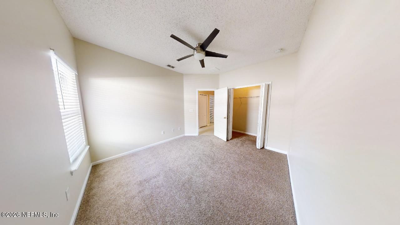 14454 Millhopper Road Jacksonville, FL 32258 - Photo 29 of 44 a view of a livingroom with a ceiling fan and window